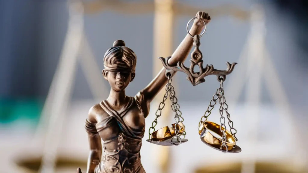 Lady Justice statue holding balanced scales.
